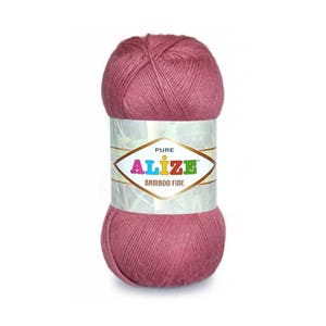 May include: A skein of pink yarn labelled "PURE ALIZE BAMBOO FINE".