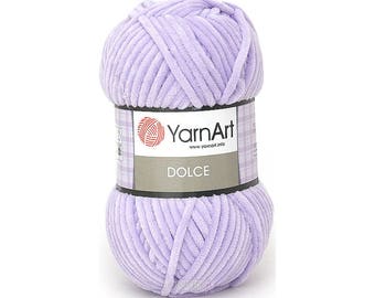 May include: A skein of lavender yarn called "Dolce" by YarnArt. The yarn is a soft, fluffy texture and is perfect for knitting or crocheting.