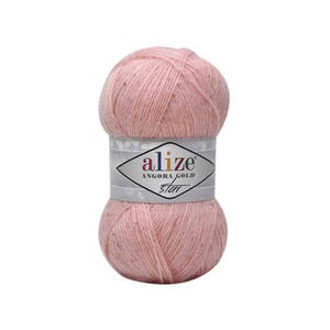 May include: A pink ball of yarn with a white label that says "alize' Angora Gold Star".