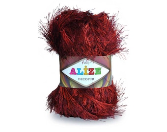 May include: A skein of red yarn with a fluffy texture. The yarn is labeled "Alize Decofur Fancy".