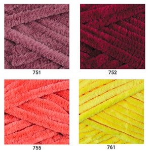 May include: A collection of yarn skeins in various colors, including pink, red, orange, yellow, green, brown, and gray. The yarn is soft and fluffy, and it is perfect for knitting or crocheting.