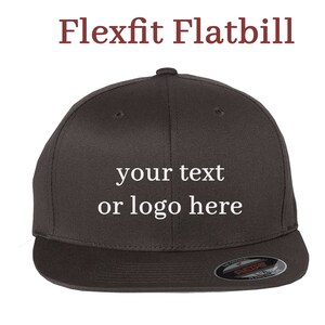 May include: A dark grey Flexfit flatbill baseball cap with the text "your text or logo here" embroidered on the front.