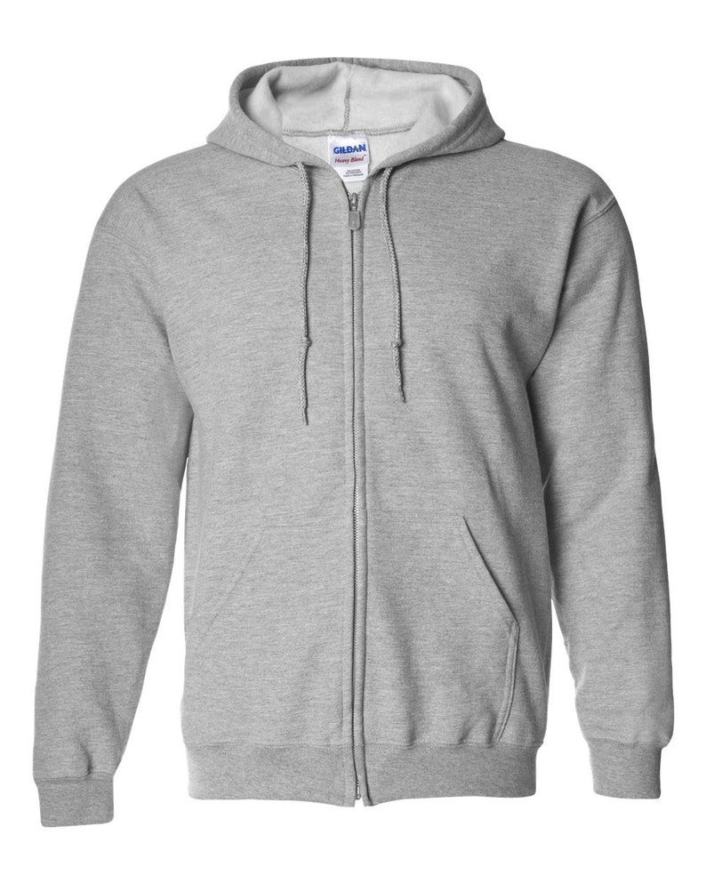 May include: A light gray zip-up hoodie with a drawstring hood and a front pocket. The hoodie has a full-length zipper and ribbed cuffs and hem. The brand name "Gildan" is visible on the label. This casual sweatshirt is suitable for everyday wear.