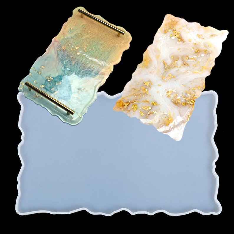 May include: A light blue silicone mold with a wavy edge. Two resin trays are shown, one with a light blue and gold design and the other with a white and gold design.