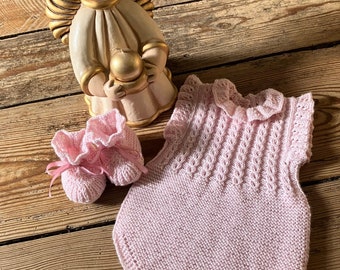 Hand knitted cute, soft, warm and snuggly baby romper with matching booties made using merino wool in pale shade of pink