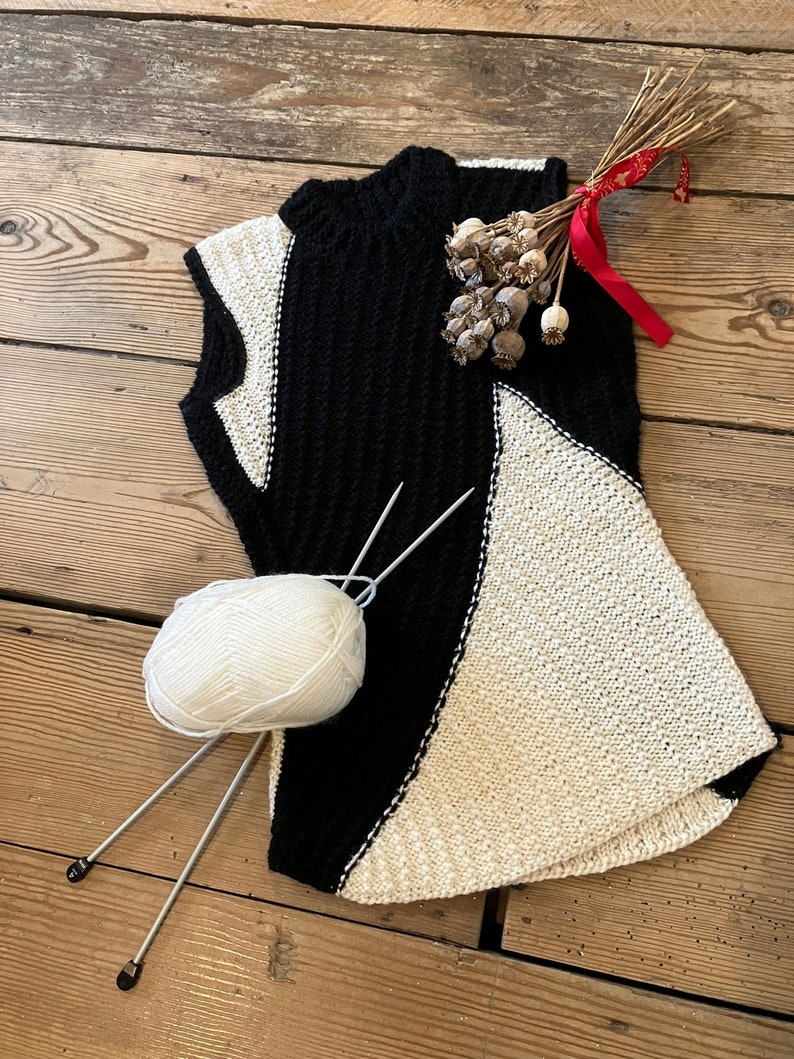 Black and white hand-knitted sleeveless jumper worked using intarsia technique to create unique asymmetric design image 1