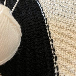 Black and white hand-knitted sleeveless jumper worked using intarsia technique to create unique asymmetric design image 6