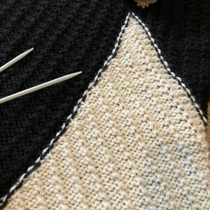 Black and white hand-knitted sleeveless jumper worked using intarsia technique to create unique asymmetric design image 8