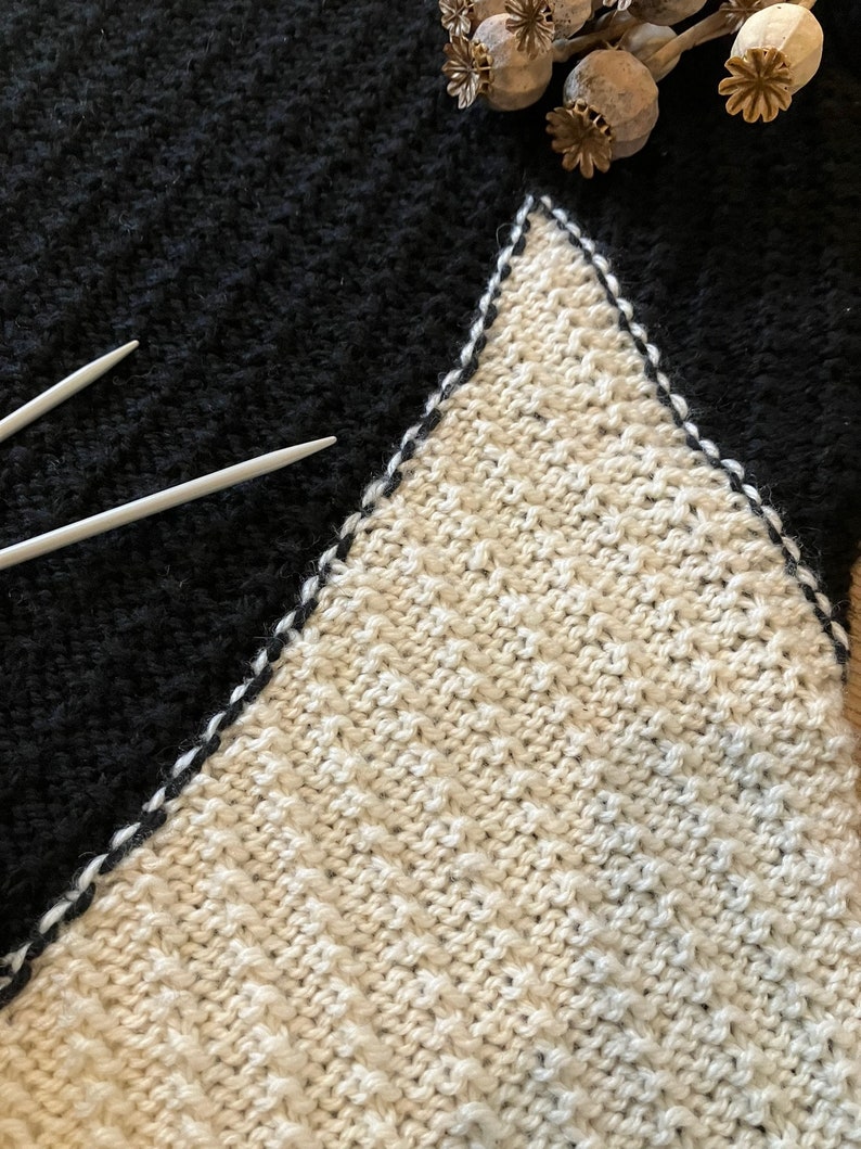 Black and white hand-knitted sleeveless jumper worked using intarsia technique to create unique asymmetric design image 8