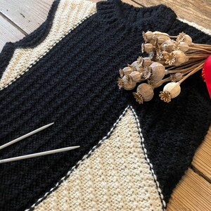 Black and white hand-knitted sleeveless jumper worked using intarsia technique to create unique asymmetric design image 3