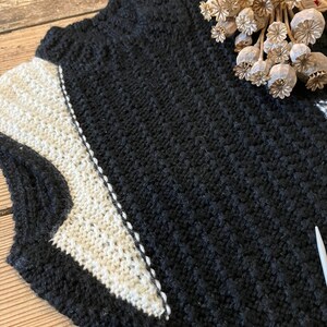 Black and white hand-knitted sleeveless jumper worked using intarsia technique to create unique asymmetric design image 5