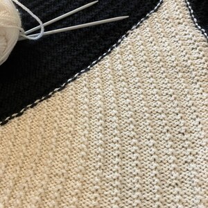 Black and white hand-knitted sleeveless jumper worked using intarsia technique to create unique asymmetric design image 4