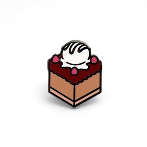May include: A small, enamel pin shaped like a square piece of cake with pink frosting, white icing, and a pink cherry on top.