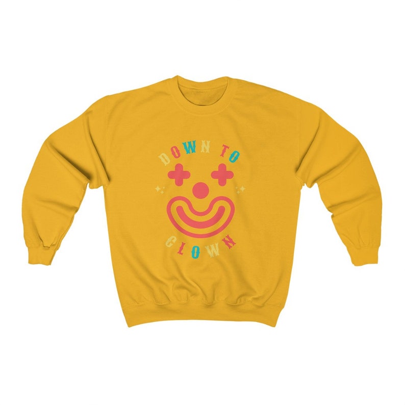 May include: Yellow sweatshirt with a colorful graphic of a clown face and the text "DOWN TO CLOWN".