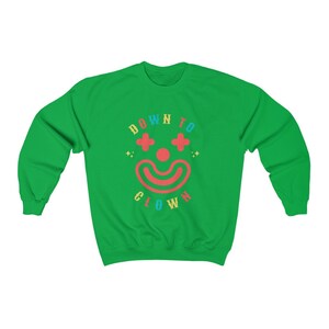 May include: Green sweatshirt with a colorful graphic of a clown face and the text "DOWN TO CLOWN".