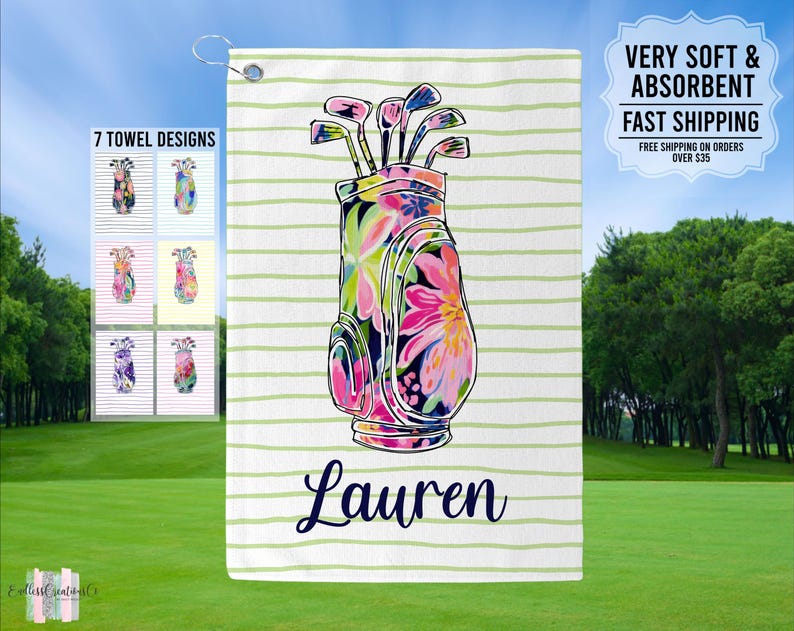 May include: A white golf towel with green stripes and a floral print golf bag design. The towel has the name "Lauren" printed on it.  7 TOWEL DESIGNS is printed on the left side of the towel.