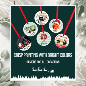 May include: A collection of round Christmas ornaments with red ribbons. Each ornament features a unique design, including a basketball, a mermaid, a golf cart, and a Christmas tree. The text "CRISP PRINTING WITH BRIGHT COLORS" is displayed.