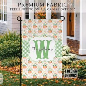 May include: A rectangular garden flag featuring a repeating pattern of orange pumpkins and green foliage on a white background. A central white scalloped frame contains a large green letter W and the text The Williams in black script lettering.
