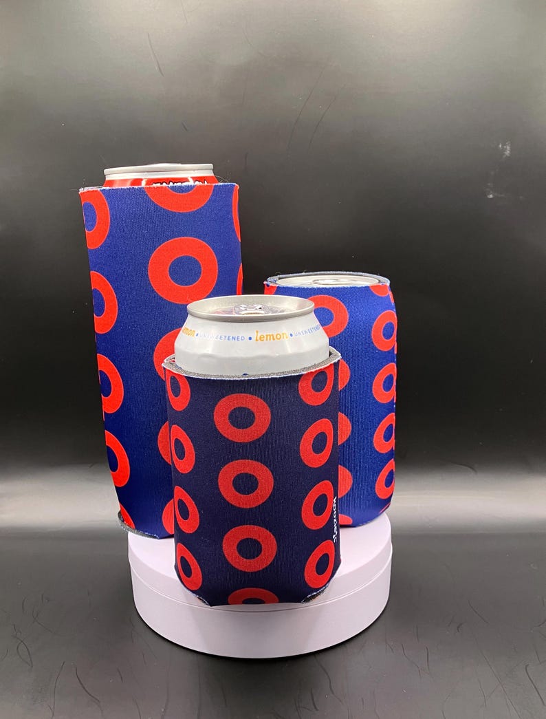 May include: Three blue and red can coolers with a donut pattern. The coolers are made of neoprene and are designed to keep drinks cold.