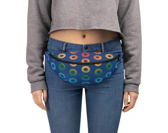May include: A fanny pack featuring a repeating pattern of colorful gradient circles in shades of red, orange, yellow, green, and blue against a solid dark blue background. The bag has a black zipper closure and an adjustable black strap.