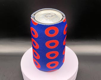 May include: A blue and red can cooler with a repeating pattern of red donuts on a blue background.