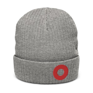 May include: Grey knitted beanie with a red circle on the cuff.