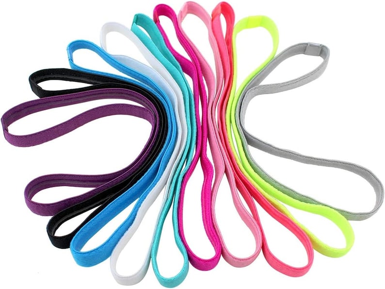 May include: A set of 12 colorful hair ties in various shades of blue, pink, purple, green, and yellow. The hair ties are made of a soft, stretchy material and are perfect for keeping hair out of the face.