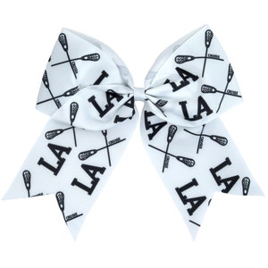 May include: White cheer bow with black lacrosse sticks and "LA" printed on it.