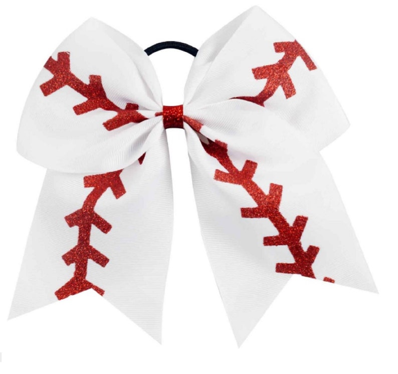 May include: White cheer bow with a red glitter baseball stitch design.