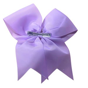 May include: A large, lavender-colored hair bow with a silver alligator clip.