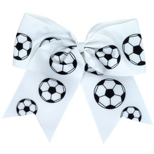 May include: White hair bow with a black soccer ball pattern.