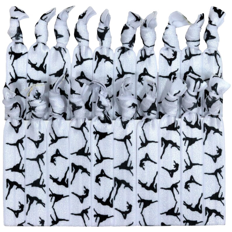 May include: A set of 20 white elastic hair ties with a black silhouette of a dancer printed on them.
