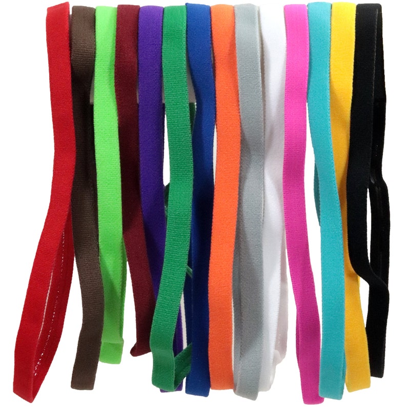 May include: A set of 14 colorful headbands made of soft, stretchy fabric. The headbands are in various colors, including red, brown, green, purple, blue, orange, gray, white, pink, turquoise, yellow, and black.