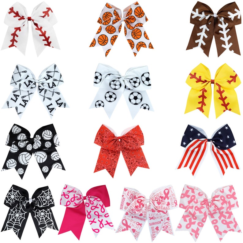 May include: Twelve different hair bows with various sports and themed designs. The bows are white with different colored patterns. The patterns include baseball, basketball, soccer, lacrosse, volleyball, American flag, pink ribbons, and a spider web.
