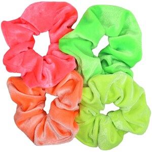 May include: Three neon-colored scrunchies in pink, orange, and green. The scrunchies are made of soft velvet and are perfect for adding a pop of color to any hairstyle.
