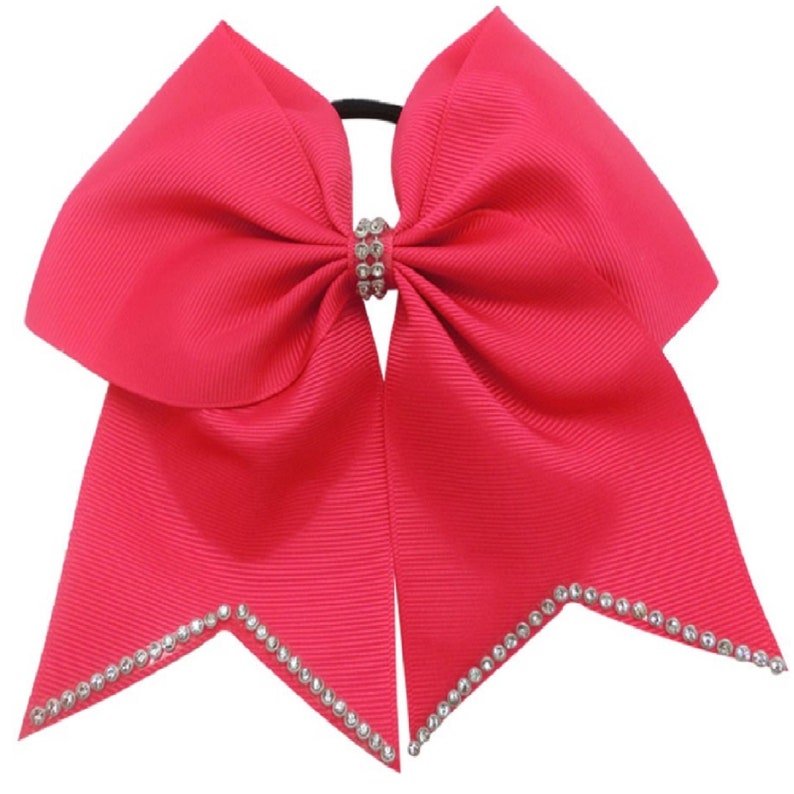 May include: A bright pink cheer bow with a rhinestone center and a rhinestone trim around the edges.