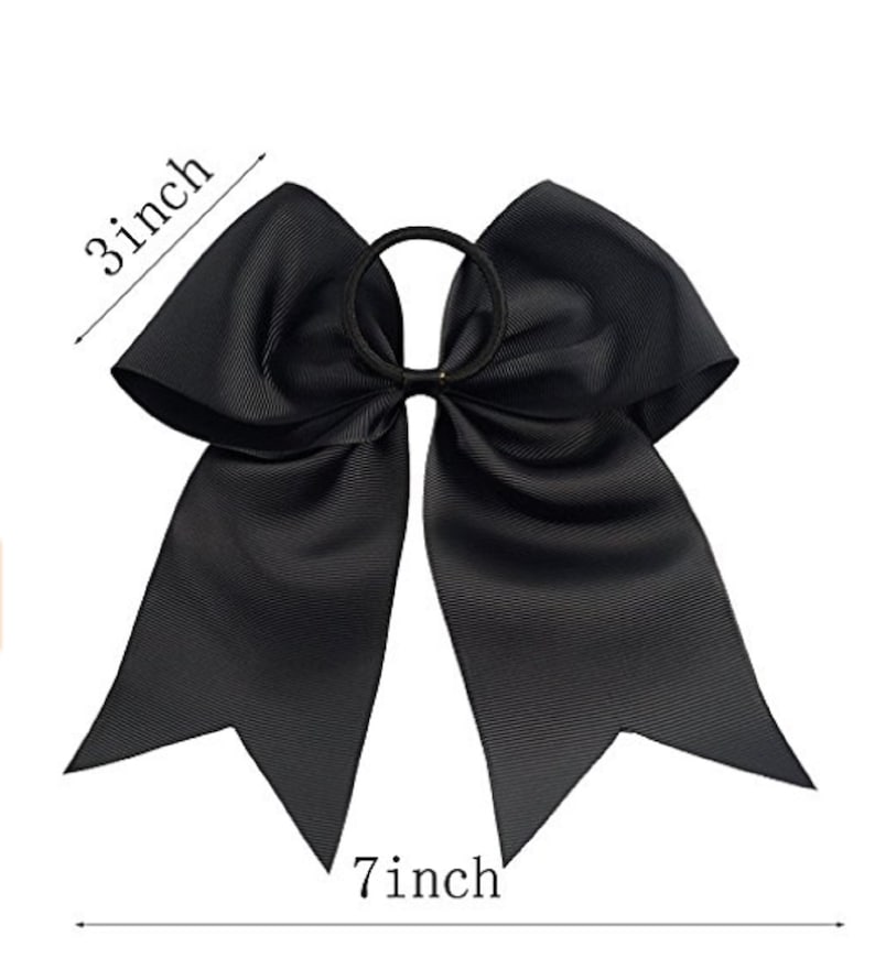 May include: A large black hair bow with a 7 inch width and 3 inch height. The bow is attached to a black elastic hair tie.