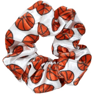 May include: White velvet scrunchie with a repeating pattern of orange basketballs.