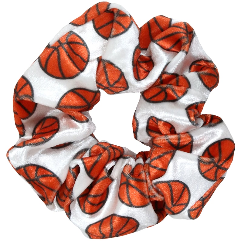 May include: White velvet scrunchie with a repeating pattern of orange basketballs.