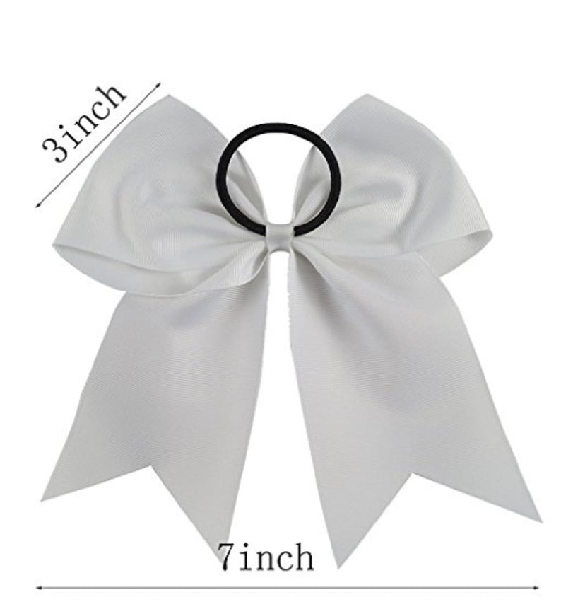 May include: White cheer bow with a 7 inch length and 3 inch width. The bow is attached to a black elastic hair tie.