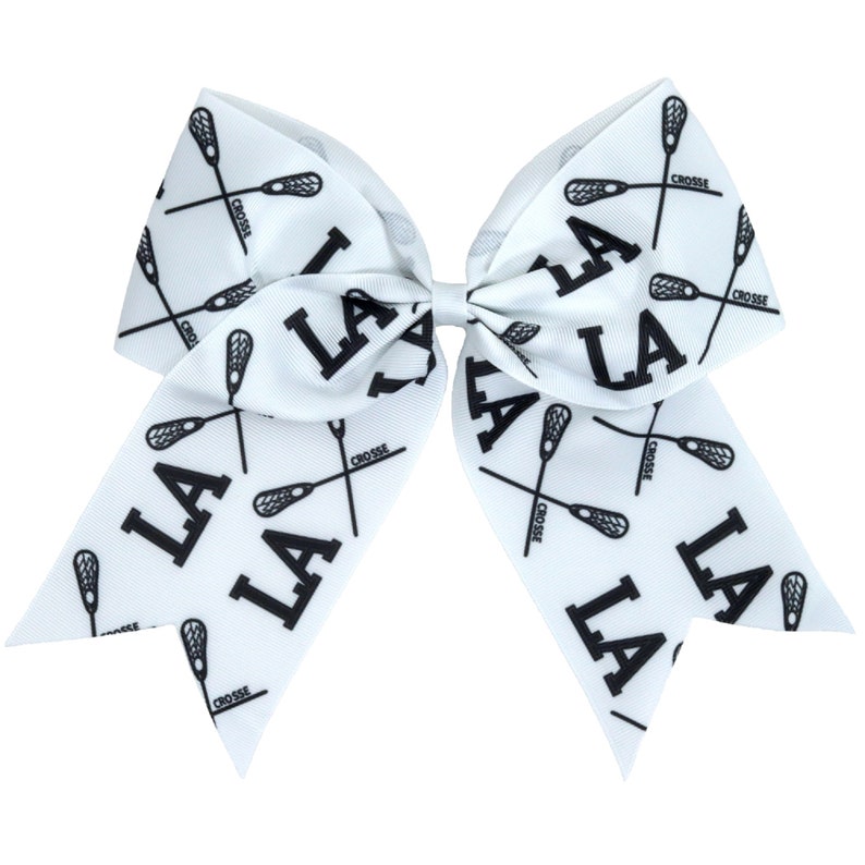 May include: White lacrosse bow with black lacrosse sticks and "LA" printed on it.