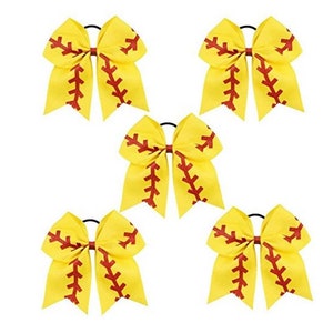 May include: Set of five yellow softball cheer bows with red stitching. Each bow has a black elastic hair tie.