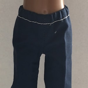 May include: A pair of dark blue pants with white stitching around the waistband and hems.