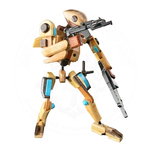 May include: A wooden robot toy with blue accents, holding a black gun. The robot is made of various pieces of wood and is posed in a standing position.