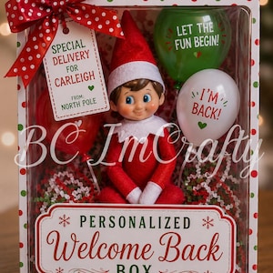 May include: A gift box with a red and white polka dot bow containing a doll in a red elf suit, a red balloon, a green balloon with text LET THE FUN BEGIN!, a white balloon with text I'M BACK!, and a tag reading SPECIAL DELIVERY FOR CARLEIGH.