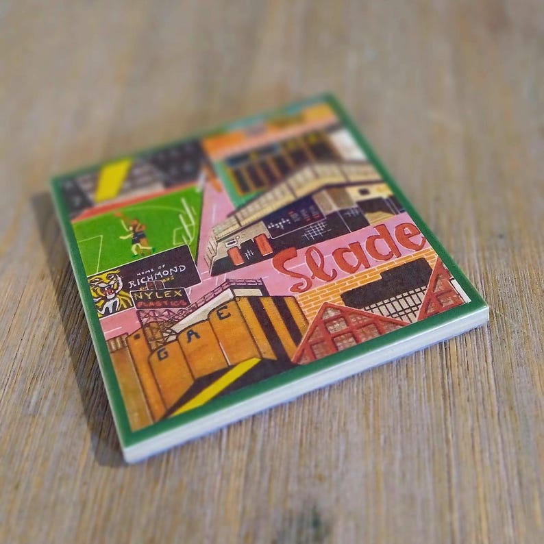 May include: A rectangular ceramic coaster featuring a colorful graphic illustration of a stadium, industrial buildings, and a sports field. The artwork includes the text "Slade," "Home of Richmond," and "Nylex Plastics" with a green border.