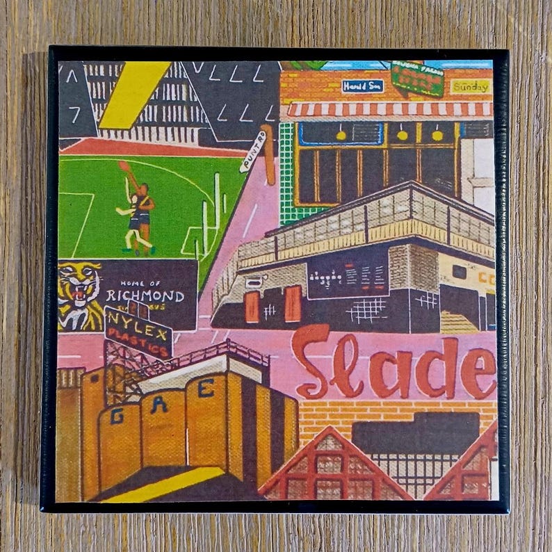 May include: A square art print featuring a stylized urban landscape with a green sports field, a tiger graphic labeled Home of Richmond, a Nylex Plastics sign, and a building with the word Slade in large red script against a brick background.