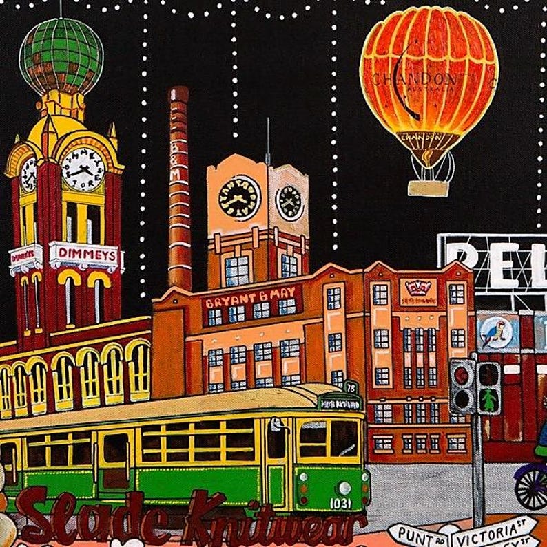 May include: A painting of a city scene at night featuring a yellow and green tram, the Dimmys clock tower, a Bryant & May factory building, and an orange Chandon hot air balloon. The text includes Dimmys, Bryant & May, Slade Knitwear, and street signs.