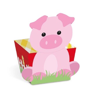May include: A pink pig sitting in a red and yellow checkered box with a white picket fence and green grass. The pig has a pink snout and black eyes.