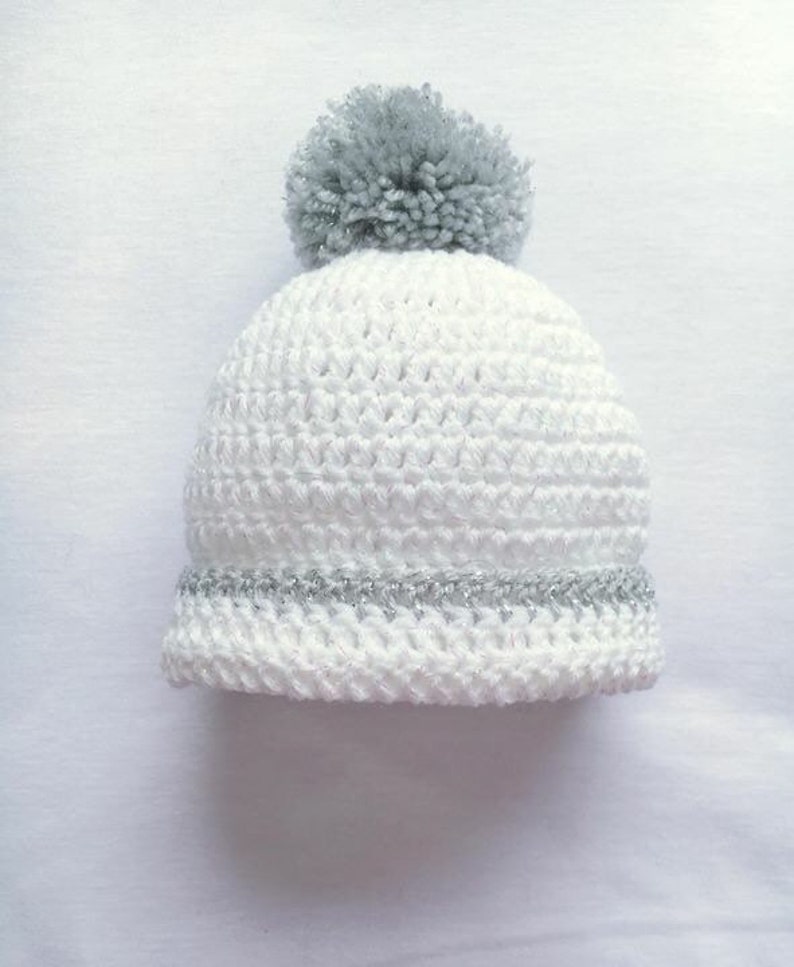 white pom pom baby hat